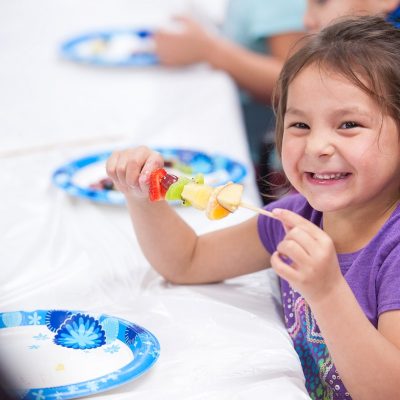 Children learn how to make fruit kebabs at the Spirit Lake Food Distribution Program located on the Spirit Lake reservation in North Dakota on November 29, 2016.